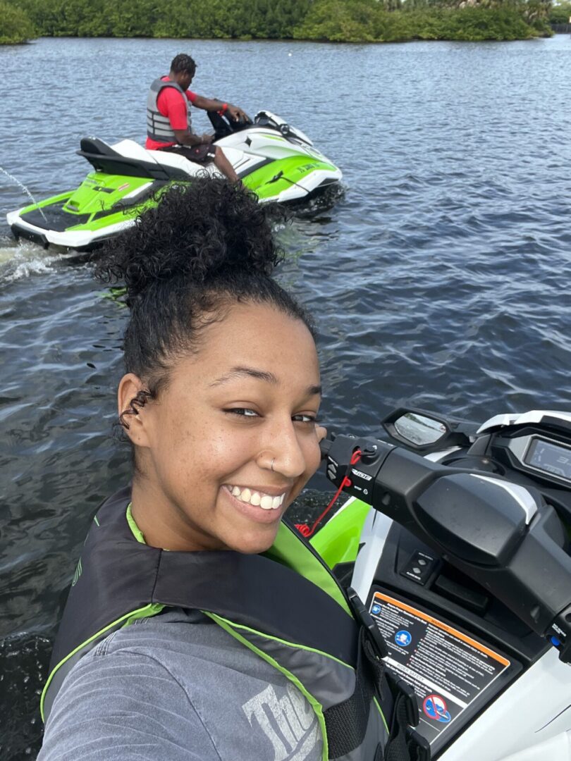 A woman posing for a picture with her speed boat
